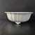 Side profile of the 17 inch white round glazed Yixing pot on dark grey