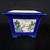 Square cobalt blue glazed Yixing pot on a dark textured background