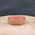 Front view of the 4.5 inch unglazed oval Yixing pot in zisha clay
