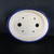 An overhead, top-down view of an 8-inch blue oval glazed Yixing bonsai pot, model number 2331d, set against a dark, matte black background. The pot's thick, rounded rim and exterior are finished in a vibrant, glossy cobalt blue glaze. The interior base of the pot is a contrasting, unglazed off-white ceramic. Functional details for bonsai cultivation are visible on the bottom, including two large circular drainage holes in the center and four smaller wire holes strategically placed for securing a tree's root ball. Near the top edge of the interior, the identification code "2331 d" is handwritten in thin red ink. The clean lines and elegant oval shape of the pot are highlighted by the simple, dark setting.