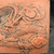 Close-up of the rectangular hand-carved dragon relief plaque