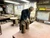 Elderly artisan potter at a wooden workbench in a ceramics workshop