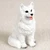 Miniature white American Eskimo dog figurine with a textured coat