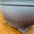 Close-up of the dark grey unglazed Bigei Tokoname round bonsai pot