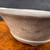 Close view of Shuho unglazed round flared bonsai pot showing clay texture