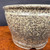 Close view of Shuho speckled glazed round bonsai pot showing glaze detail