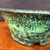 Close view of Shuho green glazed round bonsai pot showing glaze detail