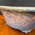 Close view of Shuho multicolor glazed round bonsai pot showing glaze detail