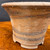 Close view of Shuho unglazed round flared bonsai pot showing clay texture and firing bands