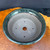 Top view of Shuho handmade dark green glazed bonsai pot with drainage hole and wire holes