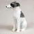 Miniature gray and white Whippet figurine seated and looking left