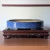 12 inch oval Yixing bonsai pot in a blue glaze, shown on a display stand