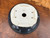 Underside of used Andy Arnault bonsai pot showing artist mark, drainage hole, wire holes, raised feet, and glossy dark exterior glaze.