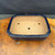 Top view of vintage Yamafusa rectangular bonsai pot showing unglazed interior, deep blue glazed rim, drainage hole, and wire holes.