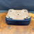 Underside of vintage Yamafusa Japanese bonsai pot showing unglazed base, drainage holes, wire holes, raised feet, and aged ceramic surface.