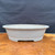 Believed Seizan / Reihou Japanese oval bonsai pot shown from the side with speckled light gray glaze, rolled rim, low feet, and refined ceramic form.