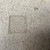 Close-up of stamped maker’s mark on the underside of a believed Seizan / Reihou Japanese bonsai pot with speckled gray ceramic surface.