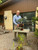 Bonsai artist Chase Rosade holding a Shimpaku Juniper planted in a Benjamin Keating steel sculpture, demonstrating the completed living composition