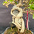 Detailed view of thick Premna roots encircling two gray rocks in the root-over-rock bonsai composition.