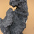 Close-up of a natural-looking opening between two sections of the handmade mountain rock with attached wire for securing planting materials.