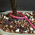 Close-up of Lavender Starflower bonsai trunk, bonsai soil and pink identification tag number 23776