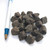 Close-up of BioGold organic fertilizer pellets next to a pen for size