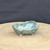 3 inch green glazed freeform bonsai pot handmade by Bruce Lenore, turned view on the stand, No. 172