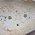 Looking into Bruce Lenore bonsai pot No. 177, showing the drainage holes and the potter's chop