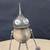 Small handcrafted found-object robot sculpture, robot 22007, closer view of the oil-can head and croquet-ball body