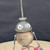 Small handcrafted found-object robot sculpture, robot 22017, closer view of the oil-can head and croquet-ball body