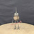 Small handcrafted found-object robot sculpture, robot 22070, full view on a wooden stool