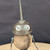 Small handcrafted found-object robot sculpture, robot 22070, closer view of the oil-can head and croquet-ball body