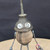 Small handcrafted found-object robot sculpture, robot 22080, closer view of the oil-can head and croquet-ball body