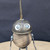Small handcrafted found-object robot sculpture, robot 22109, closer view of the oil-can head and croquet-ball body