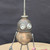 Small handcrafted found-object robot sculpture, robot 22156, closer view of the oil-can head and croquet-ball body