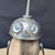 Small handcrafted found-object robot sculpture, robot 22346, closer view of the oil-can head and croquet-ball body