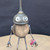 Small handcrafted found-object robot sculpture, robot 22907, closer view of the oil-can head and croquet-ball body