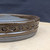 7 inch Paul Olson shallow round bonsai pot, brown glaze with stamped ring band, No. 620, close-up of the wall