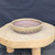 9 inch Paul Olson shallow round bonsai pot, cream glaze with stamped fret band, No. 626, angled view