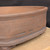 12 inch Paul Olson deep square bonsai pot, unglazed clay with beaded foot band, No. 631, close-up of the wall
