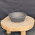 9 inch Paul Olson round bonsai pot, unglazed grey clay with carved line pattern, No. 633, angled view
