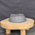 9 inch Paul Olson round bonsai pot, unglazed grey clay with carved line pattern, No. 633, underside