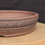11 inch Paul Olson round bonsai pot, unglazed red clay with stamped panel band, No. 636, close-up of the wall
