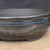 12 inch Paul Olson deep round bonsai pot, dark glaze with blue streaks, No. 639, close-up of the wall