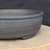 11 inch Paul Olson round bonsai pot, unglazed grey clay with impressed band, No. 640, close-up of the wall