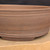 13 inch Paul Olson deep oval bonsai pot, unglazed brown clay with incised rings, No. 641, close-up of the wall