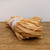 Close-up of a bundle of natural raffia used for bonsai branch protection