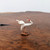 Close-up of the handcrafted white crane mudman figurine