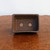 Small rectangular Udei brown unglazed pot on polished wood