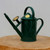 Dark green 2 pint Haws watering can on a light wooden pedestal